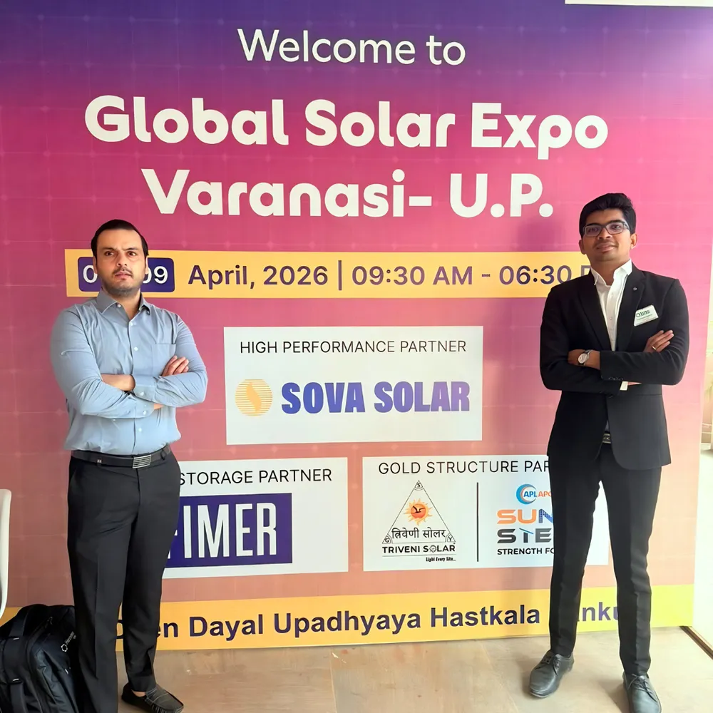 Qbits team at the Global Solar Expo Varanasi welcome board showing the April 2026 event dates