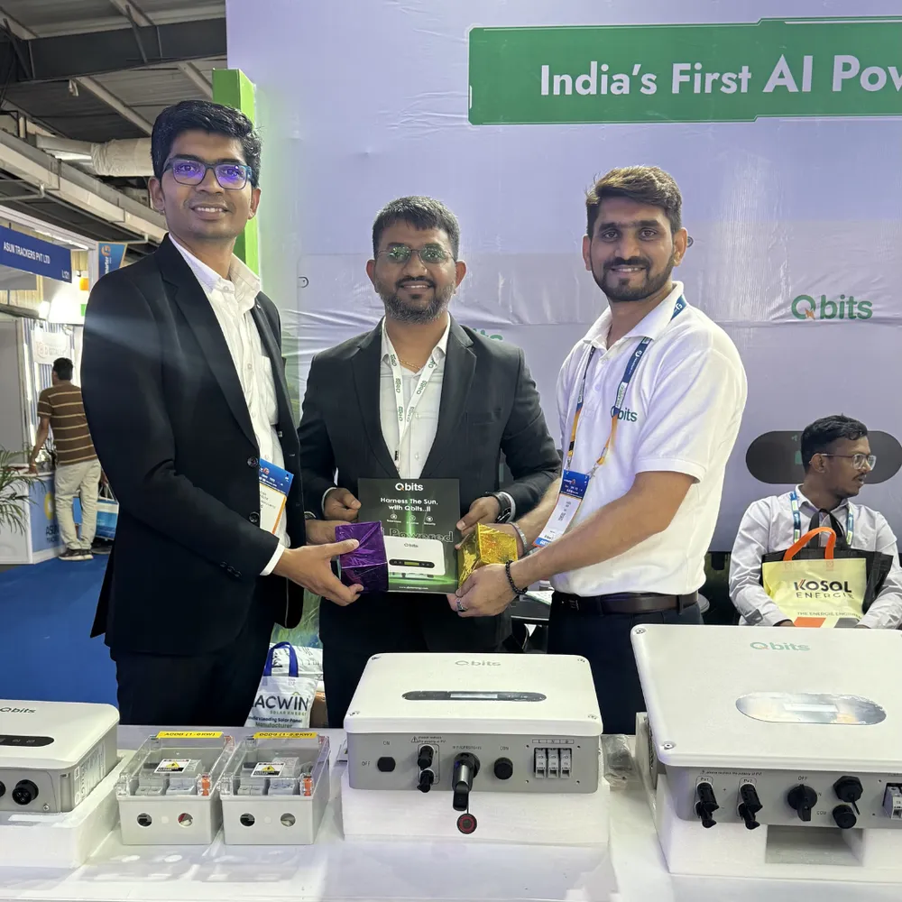 Range of Qbits on-grid and hybrid solar inverters displayed on a table at the exhibition stall