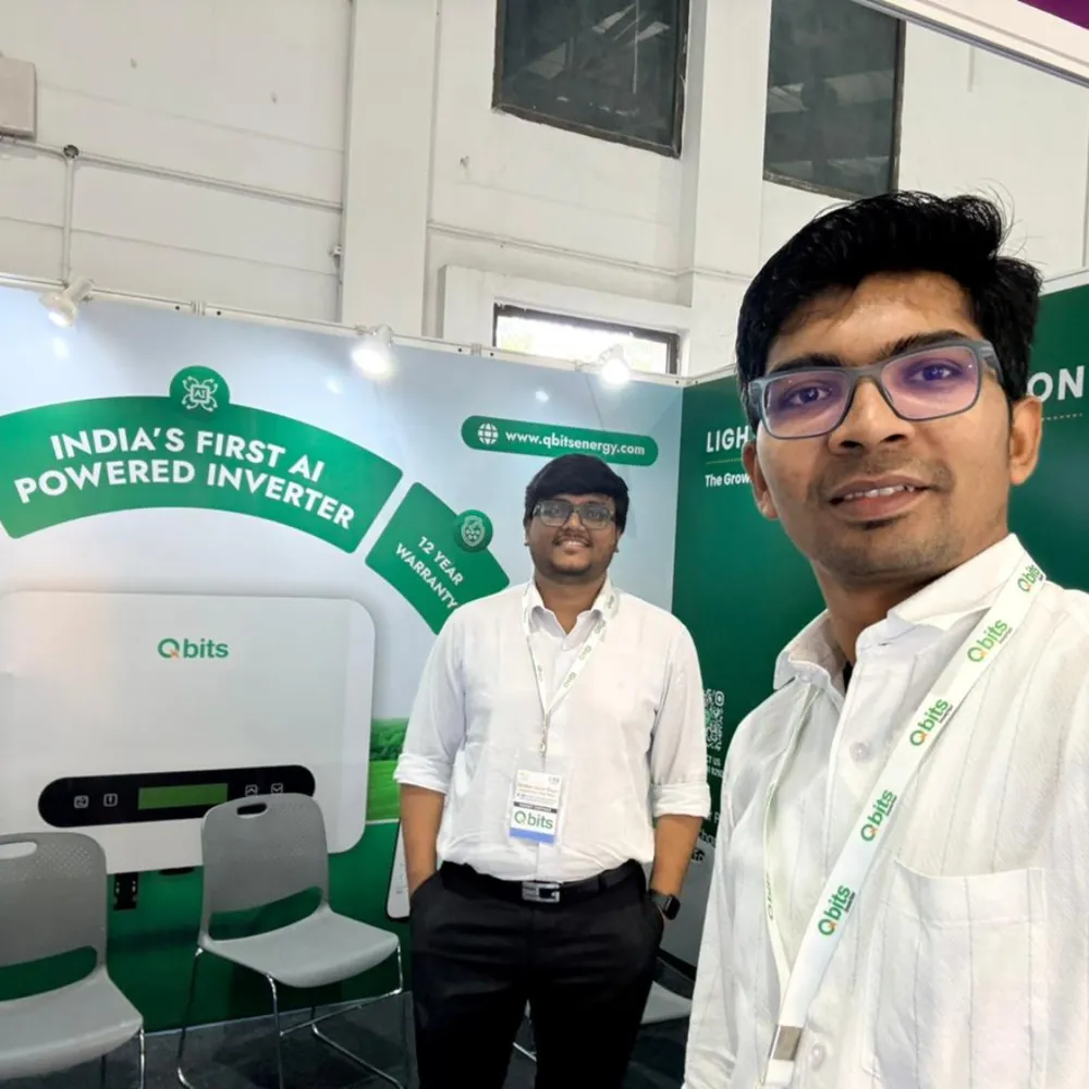 Qbits Energy exhibition stall with an AI-powered solar inverter mounted on the display wall at Global Solar Expo Varanasi