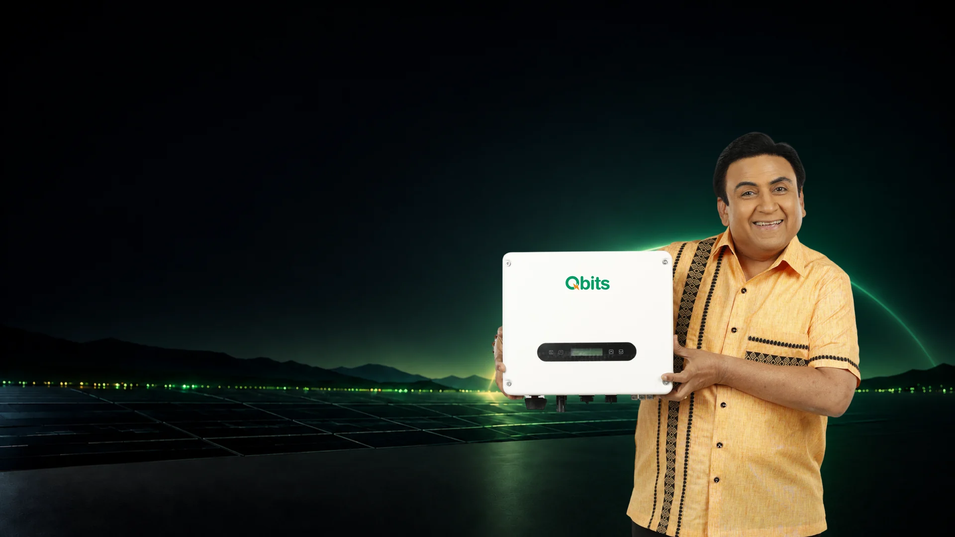 Dilip Joshi, Qbits Energy brand ambassador, holding a Qbits solar inverter